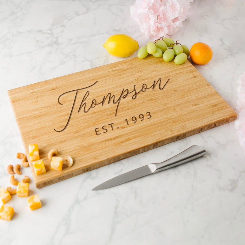 https://www.agiftpersonalized.com/cdn/shop/files/staged_cuttingboard_11x17bamboo_angled_square_Thompson_800x.jpg?v=1686657772